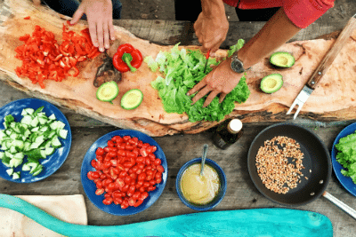 Chefs chopping food on table