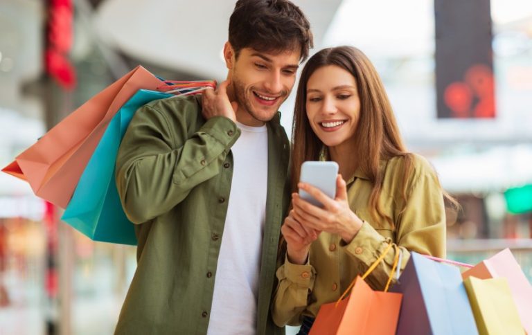 shoppers using a coalitions loyalty program app while in a mall